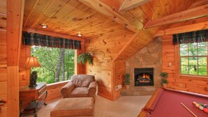 A cozy cabin interior with a fireplace, a pool table, and a comfortable seating area. - Bearfoot Memories: 180 Degree Views, Hot Tub (Gatlinburg)