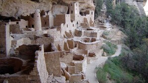 Ancient cliff dwellings with multiple levels and rooms carved into the rock. - Hot Tub, Kokopelli Kabyn, Cute and Cozy! (Blanding)