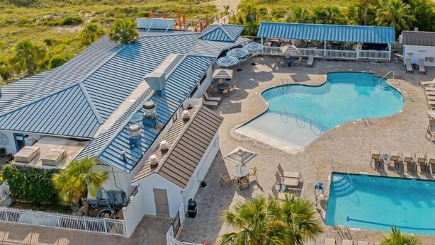 Ett semesterhotell med pool, tillgång till stranden och utsikt över havet.