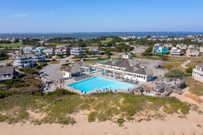 Enjoy a serene ocean view from the comfort of your home, surrounded by a large pool complex and sandy beach.