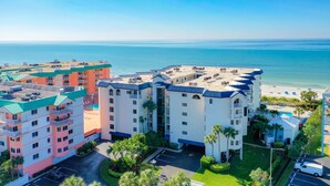 A multi-story hotel with a pool and a beach view. - Beach Palms 507 -Gulf front luxurious Condo - Spectacular Views! (Indian Shores)