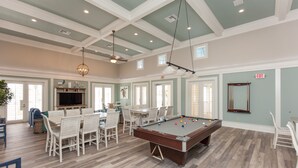 A spacious room with a pool table, dining area, and a television. - Cinnamon Beach 741 - Direct Oceanfront Corner Unit! New Living Room! (Palm Coast)
