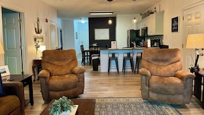 A living room with two brown armchairs, a coffee table with a plant, and a rug. - Walk-in level Vickery Resort Lakefront Condo with Dock Access for your boat! (Hollister)