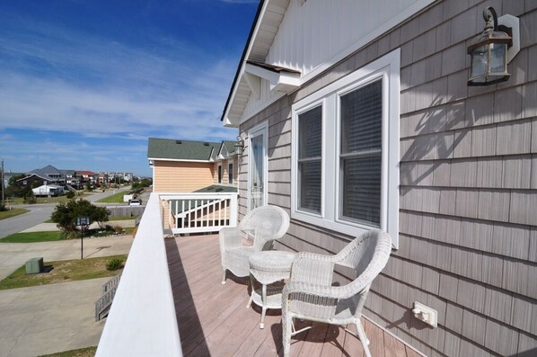 Relax on the covered porch with two comfortable chairs and a small table.
