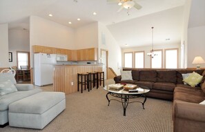 Relax in this inviting living space with a modern kitchen, sofa, and dining area.
