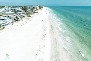 A beachside resort with multiple buildings, a sandy beach, and the ocean. - Quiet Waters Condominium 5C (Indian Shores)