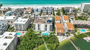 A coastal hotel with multiple buildings, a beach, and a pool area. - Quiet Waters Condominium 5C (Indian Shores)