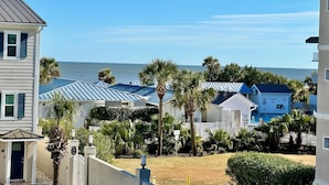 A coastal hotel with multiple buildings, a pool area, and palm trees. - Summer & July 4th Savings at Beachside Colony Tybee's ONLY Oceanfront Resort 2/2 (Tybee Island)