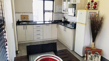 Nyala Cottage. | Private kitchen | Full-size fridge, microwave, stovetop, coffee/tea maker