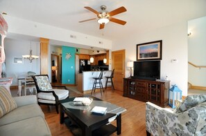 Relax in a spacious living area with a seating area, flat-screen TV, and dining space.