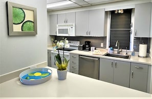 Enjoy cooking in this well-equipped kitchen with a microwave, toaster, and ample storage.