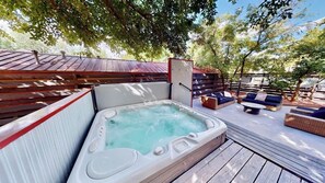 A hot tub on a wooden deck with outdoor seating and a wooden fence. - Moab Flats - 1, Instaworthy Decor and Location (Moab)