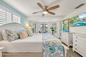 The primary bedroom pairs island-inspired details with windows overlooking the tropical backyard. - La Contento Casa | Private Heated Pool, Pet Friendly, Walk to Siesta Key Village and Beach (Siesta Key)