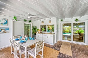 Dine al fresco under the covered lanai, with meals served fresh from the kitchen or grill. - La Contento Casa | Private Heated Pool, Pet Friendly, Walk to Siesta Key Village and Beach (Siesta Key)