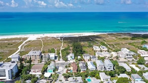 An aerial view of a coastal residential area with houses, a beach, and a clear blue sky. - 🦋 Casa De Mariposa | Heated Pool, Gulf Views, Dual-Villa Duplex, Walk to Siesta Key Beach (Siesta Key)