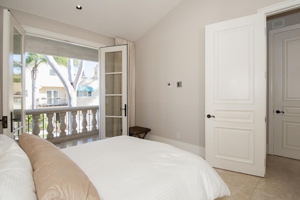 private bedroom suite on main level (2nd level) opens to a cozy balcony