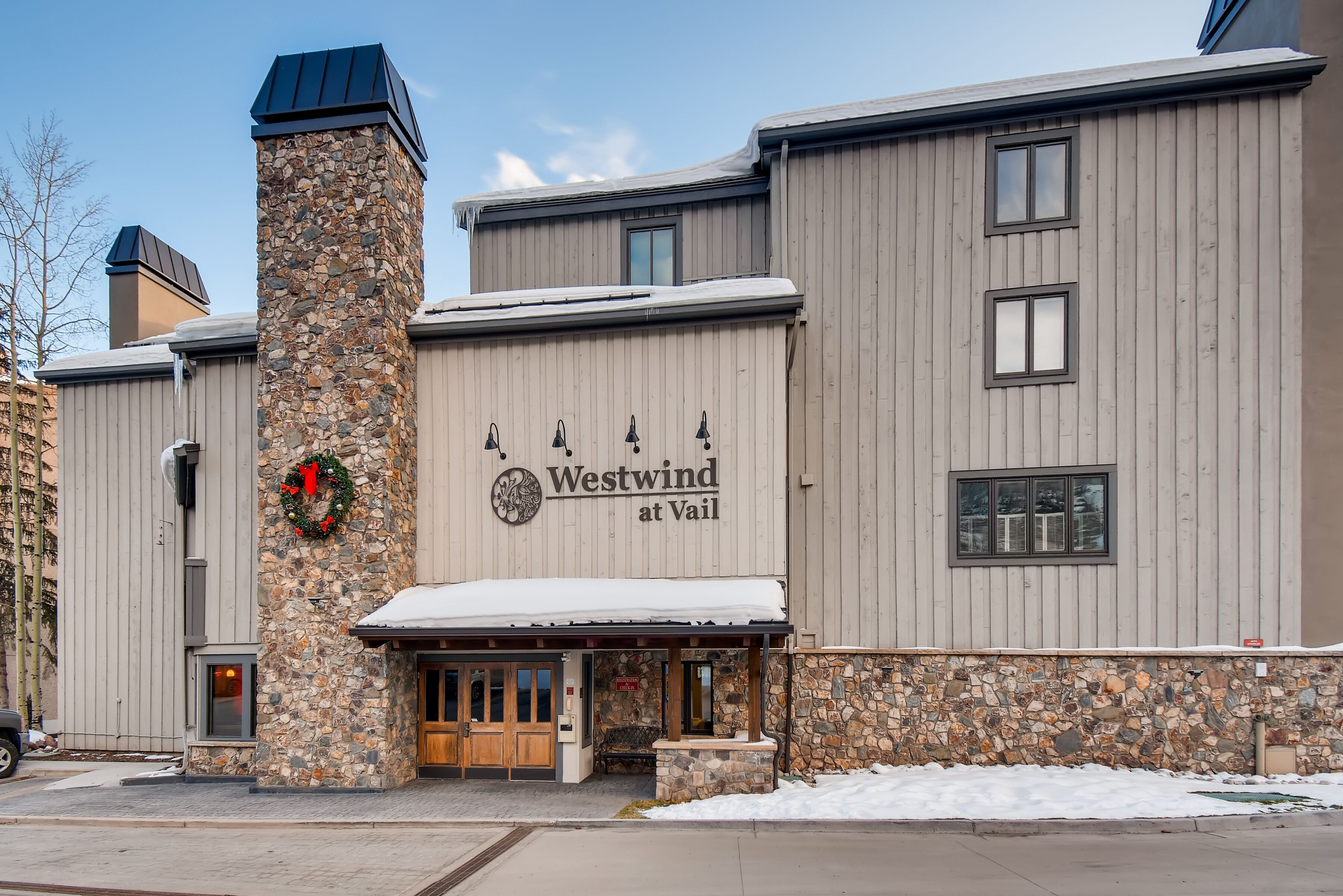 A building with a stone facade and a sign reading "Westwind at Vail."