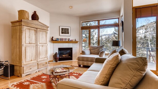 A living room with a fireplace, sofa, and large windows. - Views, Bright Spacious Vail Villa, SAV4B (Vail)