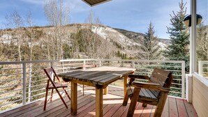 A wooden deck with a table and chairs, overlooking a mountainous landscape. - Views, Bright Spacious Vail Villa, SAV4B (Vail)