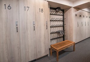 A row of wooden lockers numbered 16 to 23, a metal bench, and a wall-mounted towel rack. - Remodeled Condo Vail Mtn Views | W201 (Vail)