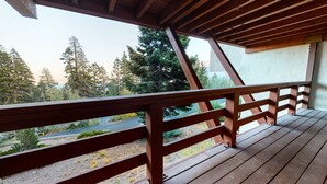 A wooden deck with a railing overlooking a road and trees. - Deluxe Mountain Townhome, 2 Master Suites. Large Private Deck & Washer/Dryer (Mammoth Lakes)