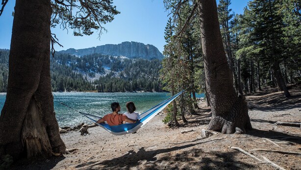 A hammock between two trees overlooking a lake with mountains in the background. - Deluxe Mountain Townhome, 2 Master Suites. Large Private Deck & Washer/Dryer (Mammoth Lakes)