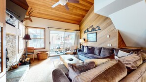 A cozy living room with a wooden ceiling, a sofa set, a coffee table, and a fireplace. - Deluxe, Remodeled Condo in a Quiet Location. Near Biking Trails & Lakes Basin (Mammoth Lakes)