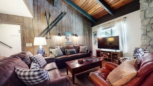 A cozy living room with a leather sofa set, a coffee table, and a flat-screen TV. - Mountain Rustic, Pool & Tennis, Near Dining, Rec Center, Bowling & Trails (Mammoth Lakes)
