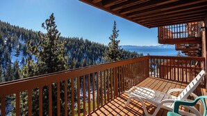 A wooden deck with a view of a forest and a lake. - 93 Bitterbrush | 4BR/3.5BA Incline Village | Lake Views (Incline Village)