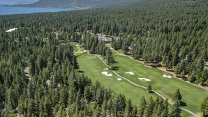 A golf course surrounded by dense forest and mountains. - 93 Bitterbrush | 4BR/3.5BA Incline Village | Lake Views (Incline Village)