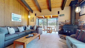 Relax in this inviting living area with a comfortable sofa, dining table, and brick fireplace.