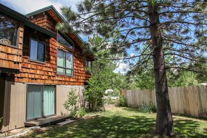 Relax in a serene outdoor space with a spacious deck and well-maintained lawn.