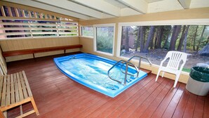 An indoor swimming pool with wooden deck, a bench, and a chair. - Mammoth Ski & Racquet Club #129, 1 Bdrm + Loft (Mammoth Lakes)