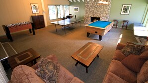 A spacious living area with a pool table, foosball table, and comfortable seating. - Discovery 4 #113 1 Bedroom 1 Bath (Mammoth Lakes)