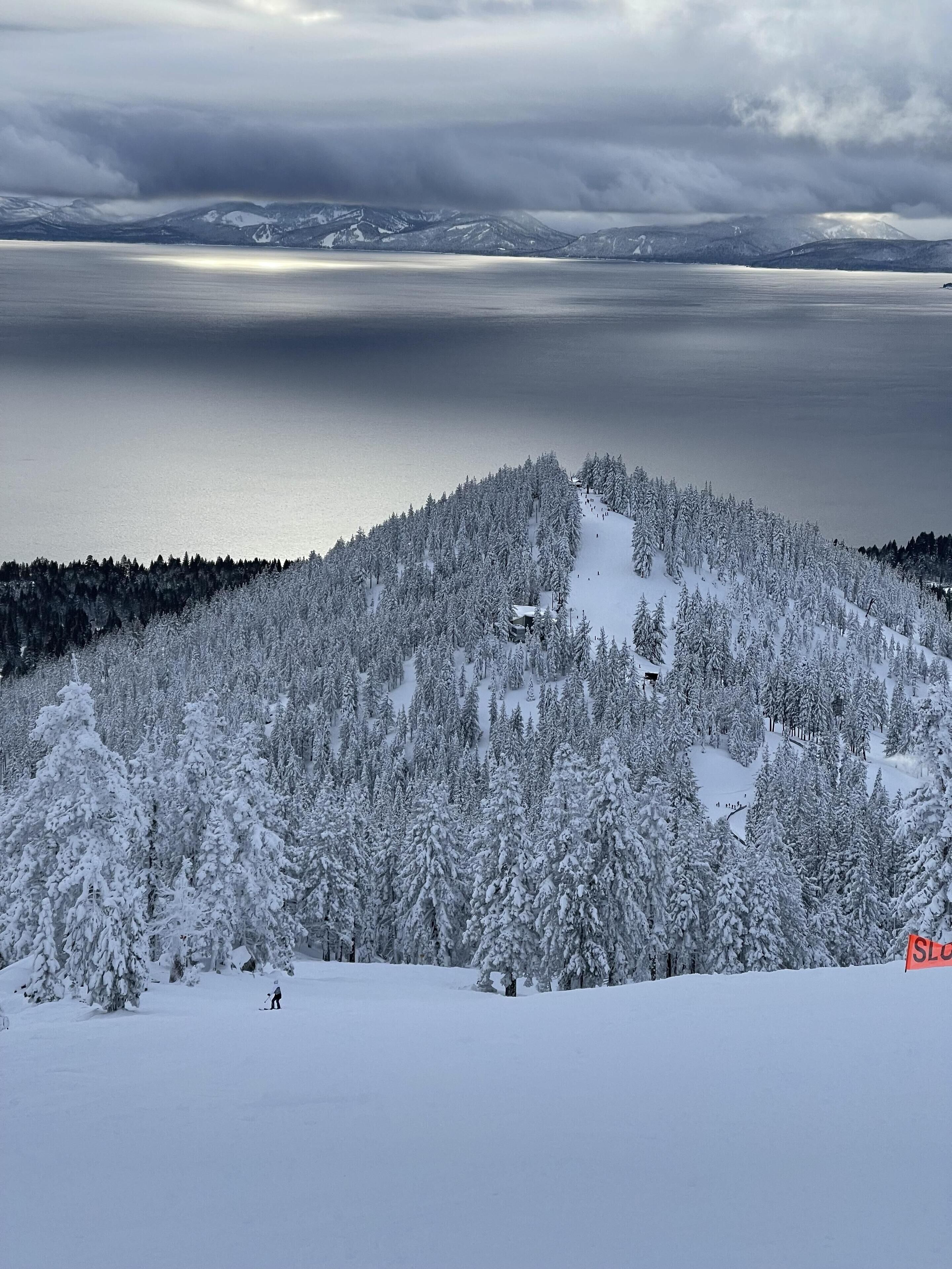 A snow-covered mountain with a ski resort, including ski slopes and a lodge.