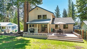 A two-story house with a covered patio, a deck, and a small outdoor kitchen. - 206 Nadine | 3BR/2.5BA Incline Village | Fireplace & Patio (Incline Village)