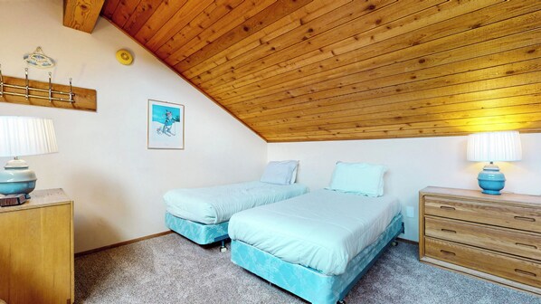 A bedroom with two beds, a wooden ceiling, a wall-mounted picture, and a bedside table with a lamp. - Large Home, Complex Hot Tub, Steps To Winter Shuttle & Wood Burning Fireplace (Mammoth Lakes)
