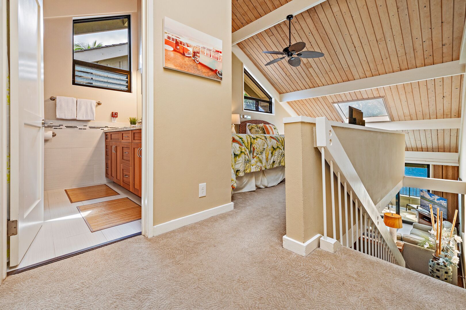 A spacious interior with a high ceiling, a staircase, and a view of the outdoors.