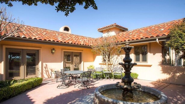 A courtyard with a fountain, outdoor seating, and a building with a tiled roof. - Vineyard Views + Jetted Tub | Paso Robles Wine Country | Solitude I (Paso Robles)