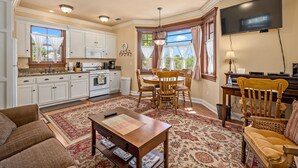 A spacious living area with a dining table, chairs, a sofa, and a TV. - 2 Ensuite Suites + Walk to Downtown | Paso Robles | Lewis Loft (Paso Robles)