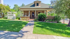 A single-story house with a front porch, a small attached garage, and a well-maintained lawn.