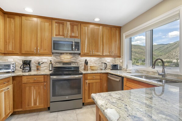 Enjoy cooking in this well-equipped kitchen with a large island and appliances.