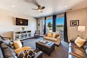 Living Room - This beautifully decorated living room is conveniently adjacent to the Kitchen and has access to the back patio where you will find your BBQ Grille and patio table.