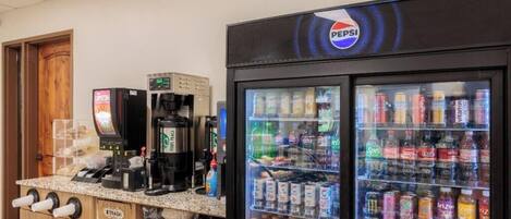A vending machine area with Pepsi and Sprite options, a coffee machine, and a trash bin.