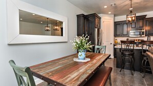 A modern kitchen with dark cabinets, a stainless steel refrigerator, and a built-in microwave. - Stylish 4BR on the 18th - Rooftop Deck, Near Pool (St. George)