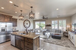 Enjoy cooking in this well-equipped kitchen with a central island, dining table, and cozy seating area.