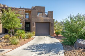 Stunning two-story residence with a stone facade and beautifully landscaped grounds.