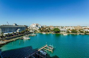 A waterfront cityscape with buildings, a marina, and a dock.