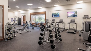 A gym with treadmills, weight machines, and free weights. - Sweeping Red Rock Views - 4BR close to Pool & Hot Tub (St. George)