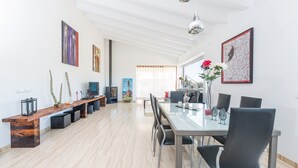A spacious dining area with a long wooden bench, modern chairs, and a glass table. - ES SERRAL - Villa with private pool in sa Pobla. Free WiFi (Sa Pobla)